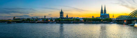 COLOGNE, GERMANY, AUGUST 11, 2018: Sunset view of cityscape of Cologne with Hohenzollern bridge, cathedral and Saint Martin church, Germany
