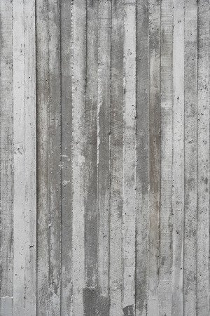 texture of wooden form work stamped on a raw concrete wall as background